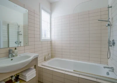 Large upstairs family bathroom with a deep soaking bath tub and separate shower at Crab Shack Cottage.