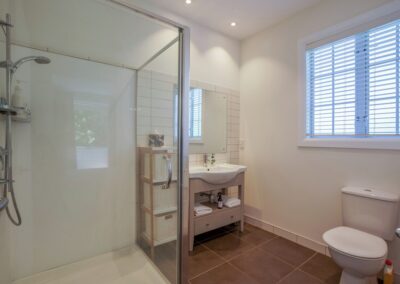 Private tiled ensuite bathroom attached to the upstairs master bedroom at Crab Shack Cottage.