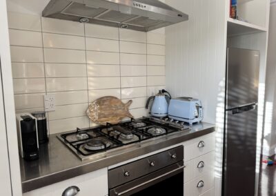 Fully equipped gourmet self-catering kitchen with modern stainless steel appliances at Crab Shack Cottage.