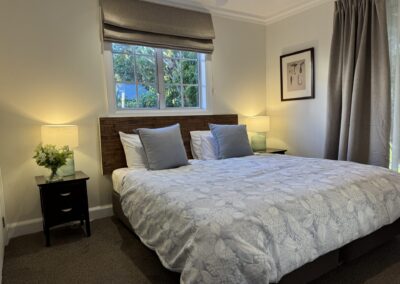 Alternative view of the ground floor master suite showing modern furnishings and window layouts.