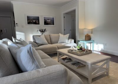 Open-plan living room lounge featuring comfortable coastal styling and deep seating at Crab Shack Cottage.